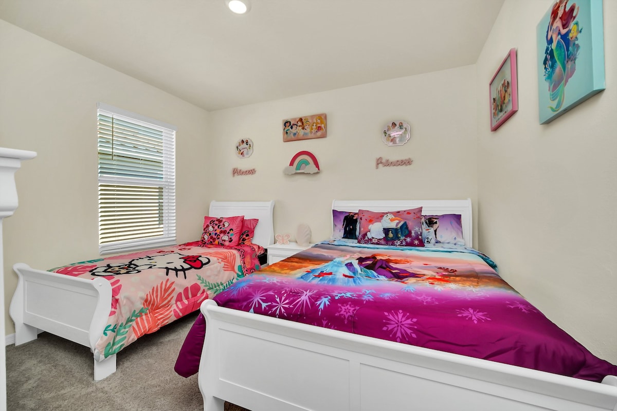 Charming themed bedroom with vibrant bedding and playful decor, perfect for a magical stay for kids.