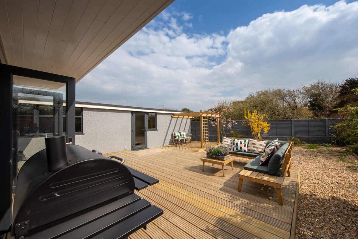 The backyard is surrounded by a tall fence for added privacy