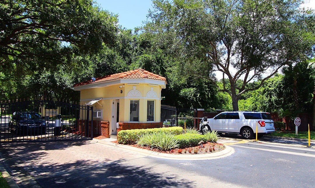 Gated entry area w/ covered seating and landscaped surroundings.