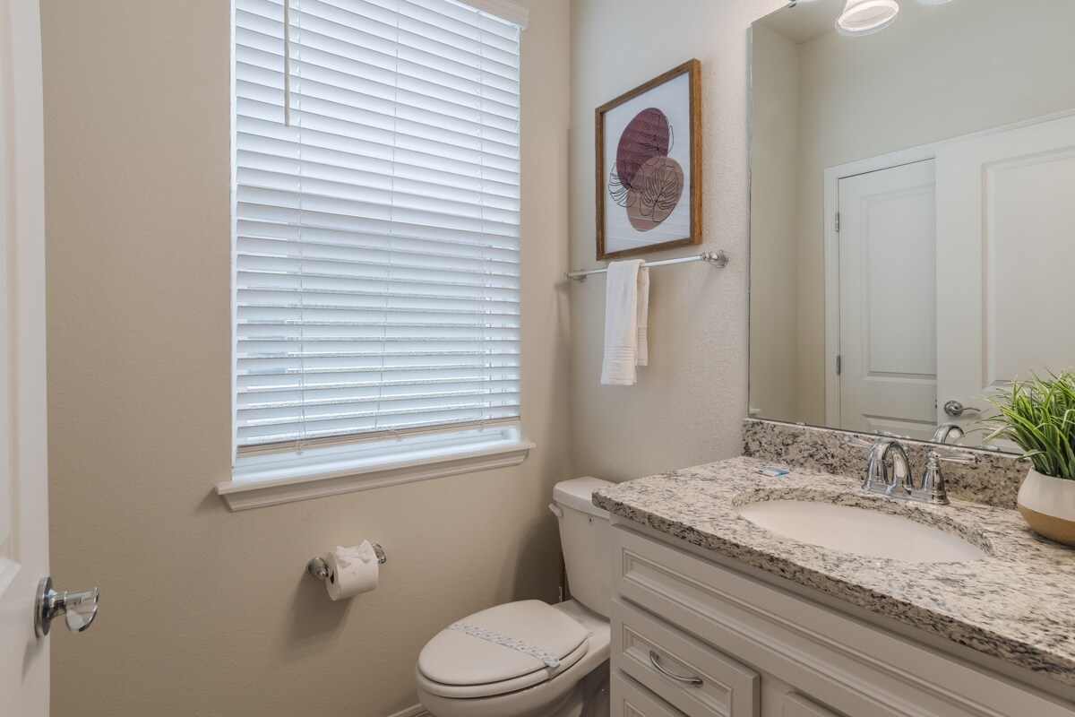 Half bathroom located downstairs adds extra convenience for guests.