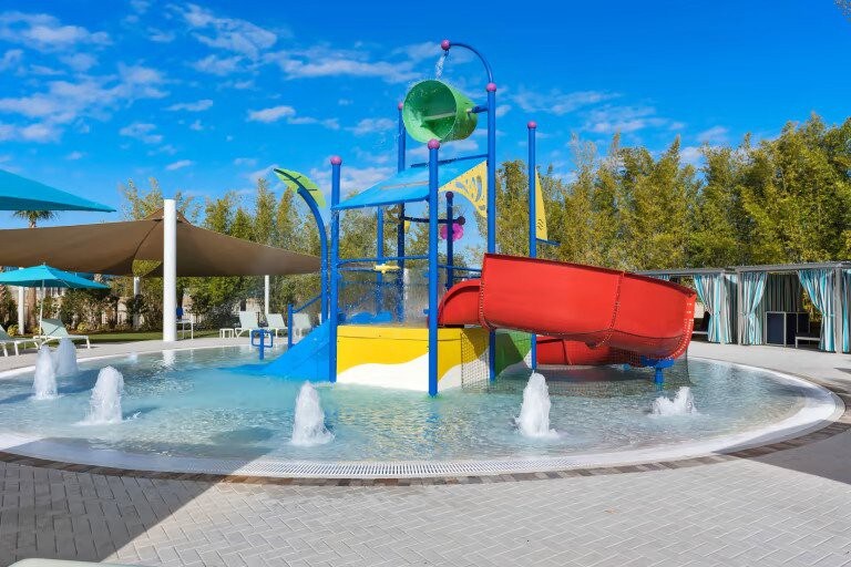 Children’s splash pad adds colorful water fun for younger guests.