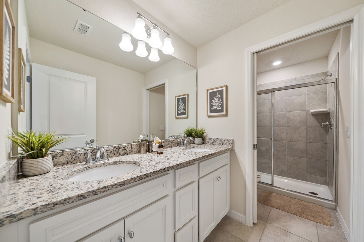 bathroom offers convenient access from both adjoining spaces