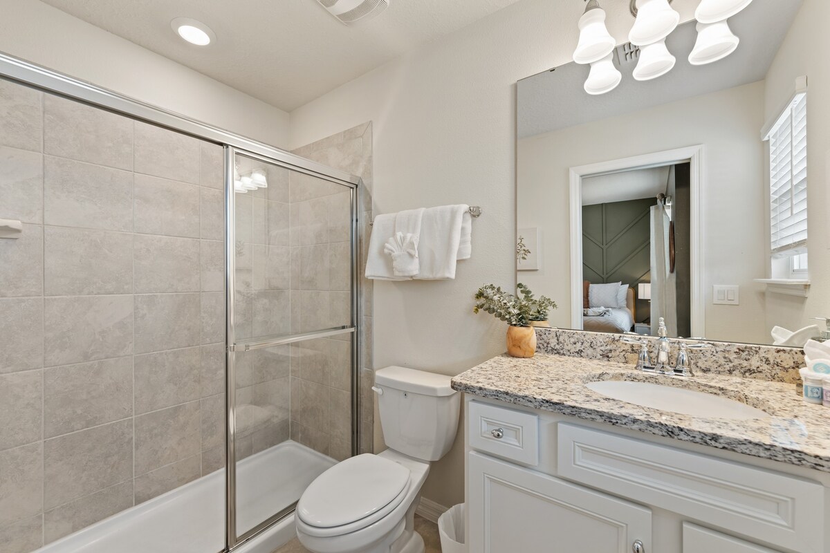 Spacious full bathroom showcases elegant tile and clean finishes.