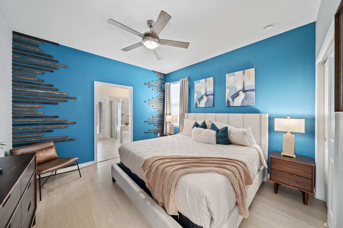Bright bedroom w/ calming tones sets a peaceful place to unwind.