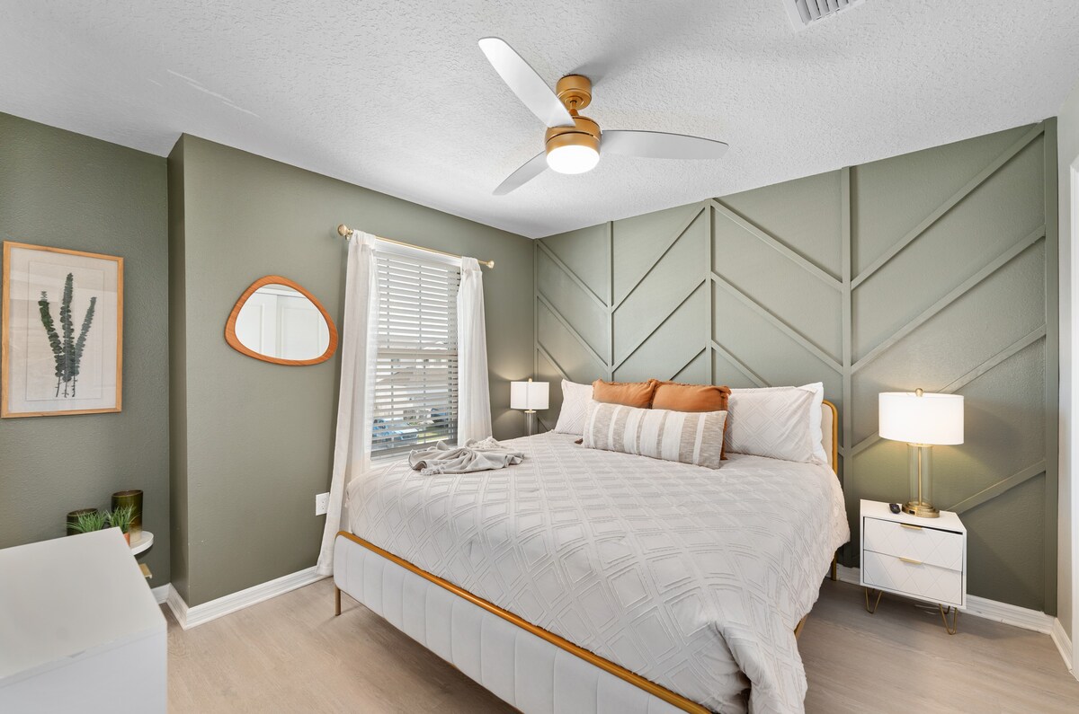 Upstairs bedroom features a comfortable bed and bright, inviting design.