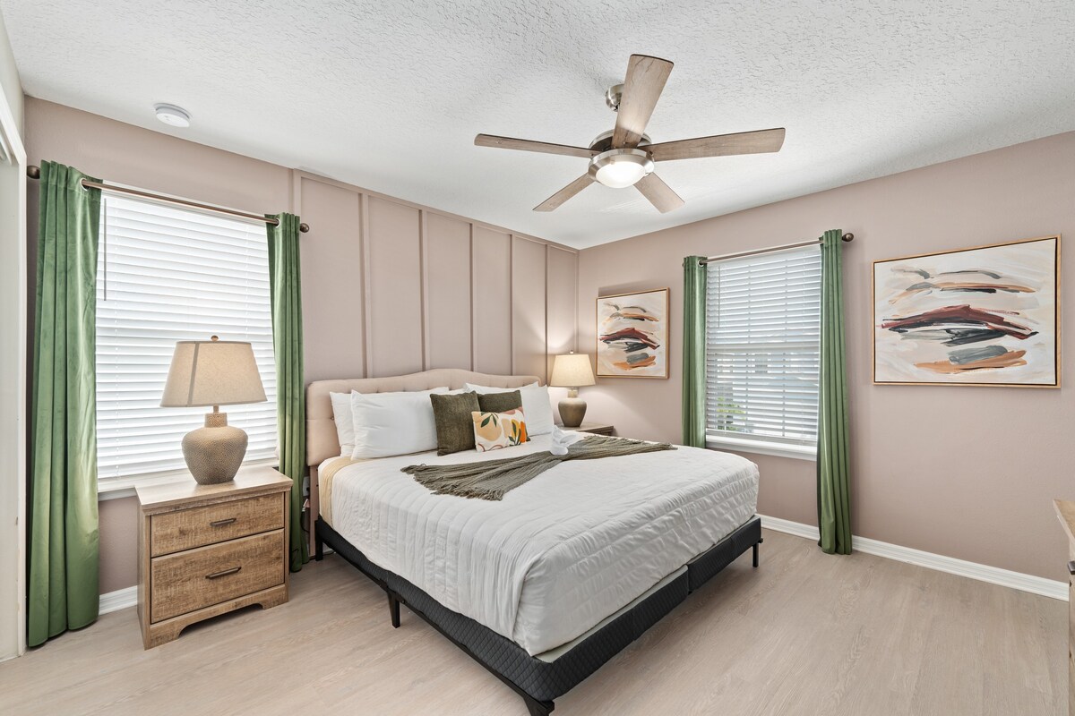 Upstairs bedroom offers a cozy retreat w/ calming tones and comfortable bed.