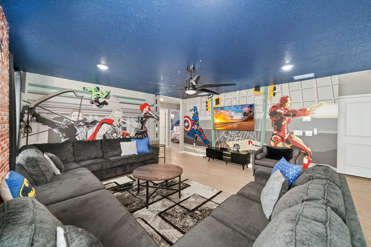 Avengers-themed lounge w/ plush seating and bold wall art creates an immersive hangout space.