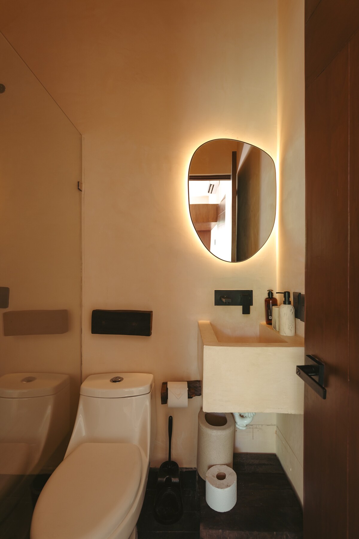 Modern full bathroom located in the bedroom.