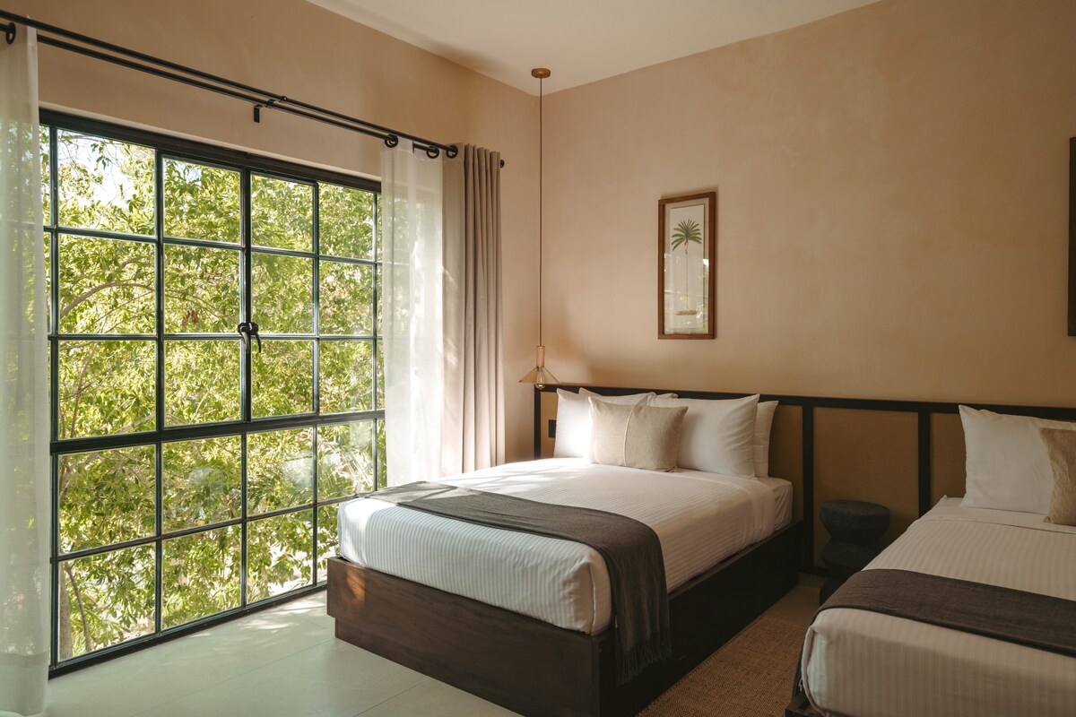 Spacious bedroom located on the second floor with two beds.