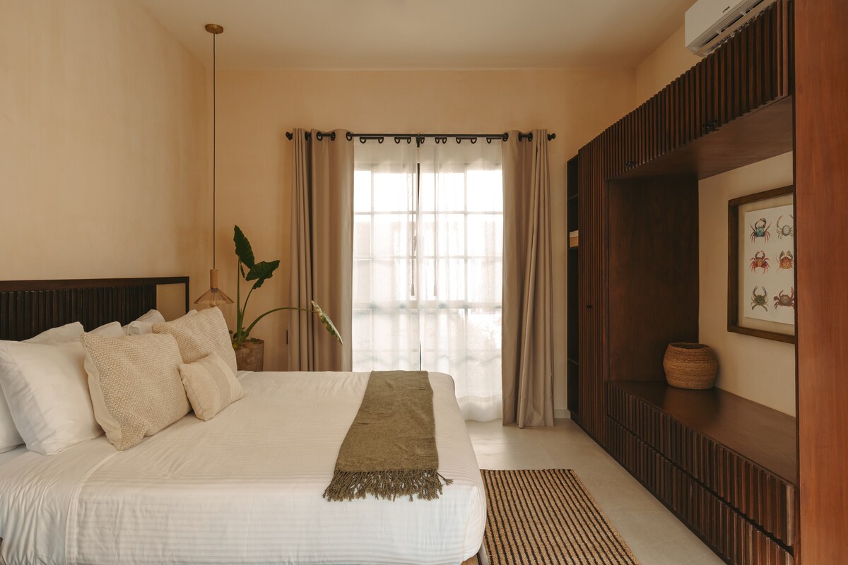 Master bedroom with a king-size bed, located on the second floor.
