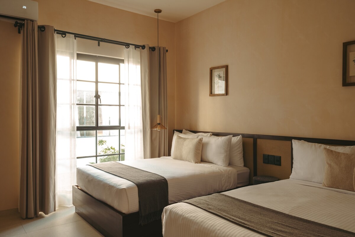 Spacious bedroom with two double beds.