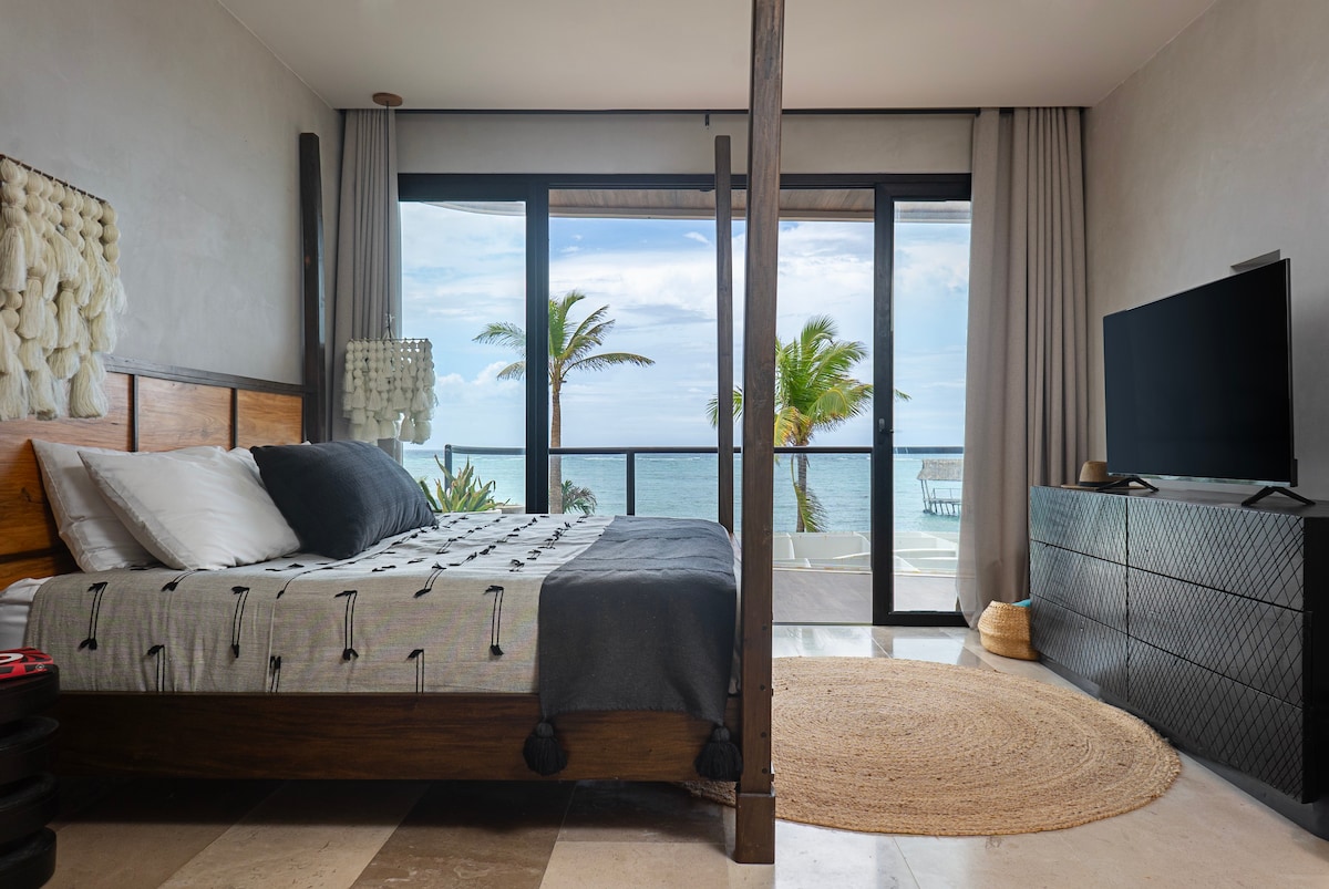 Bedroom with a king-size bed. It includes a TV, AC, and fantastic ocean views.