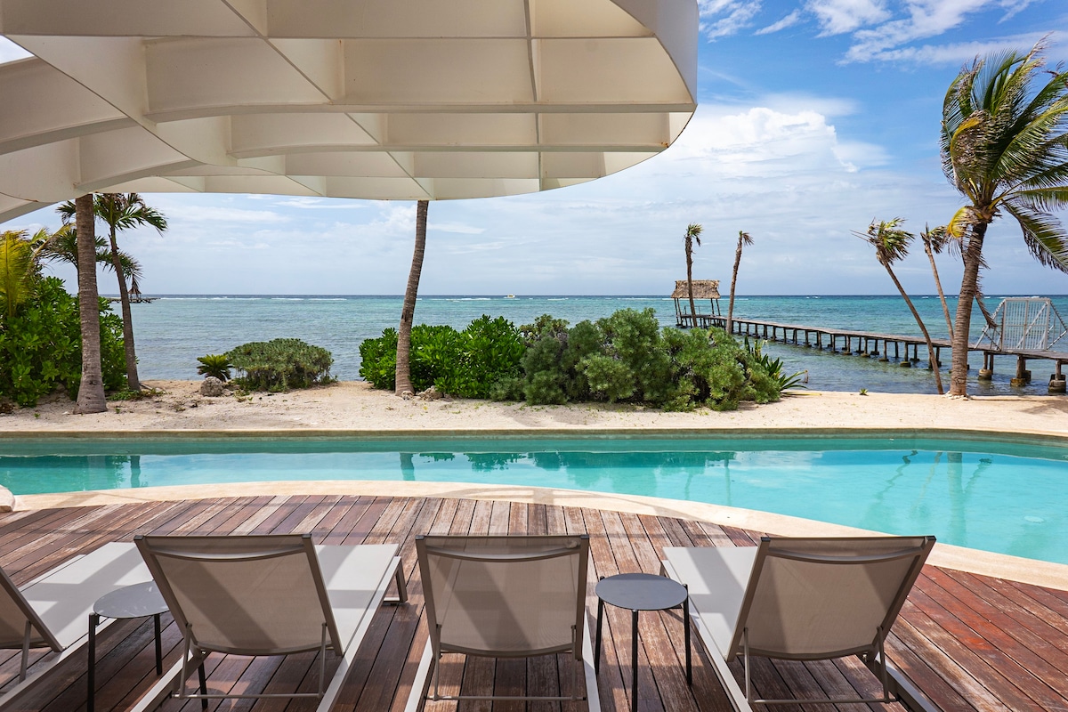 Beautiful sundeck in the complex. It features a pool, lounge chairs, and stunning ocean views.