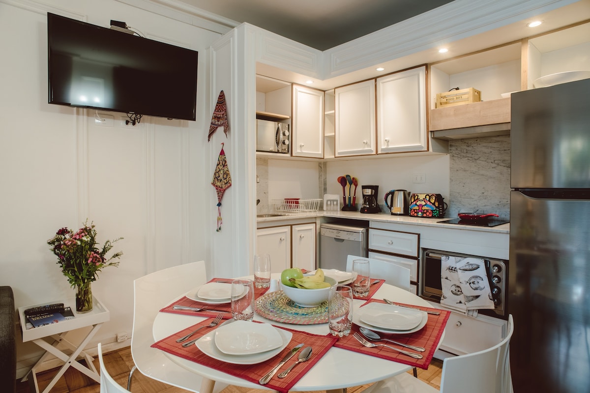 Charming kitchen and dining area with modern amenities and vibrant decor, perfect for cozy meals and relaxation.