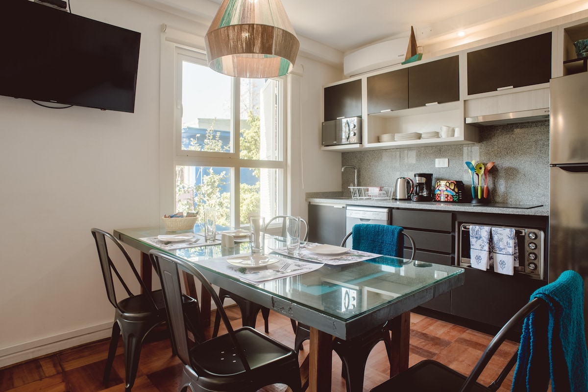 Bright and modern kitchen with a glass-top dining table, perfect for enjoying meals with a view.