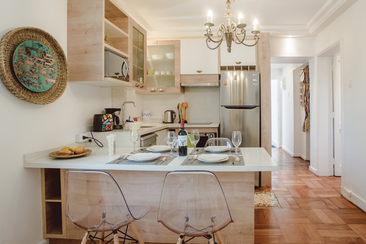Charming kitchen with a cozy breakfast bar and elegant chandelier, perfect for morning coffee or intimate dinners.