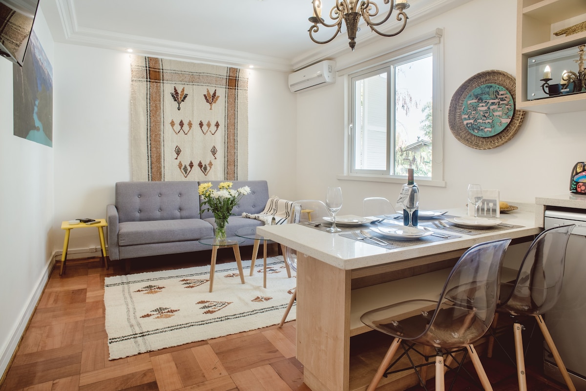 Charming living space with cozy seating and elegant dining area, perfect for relaxing and enjoying a meal.