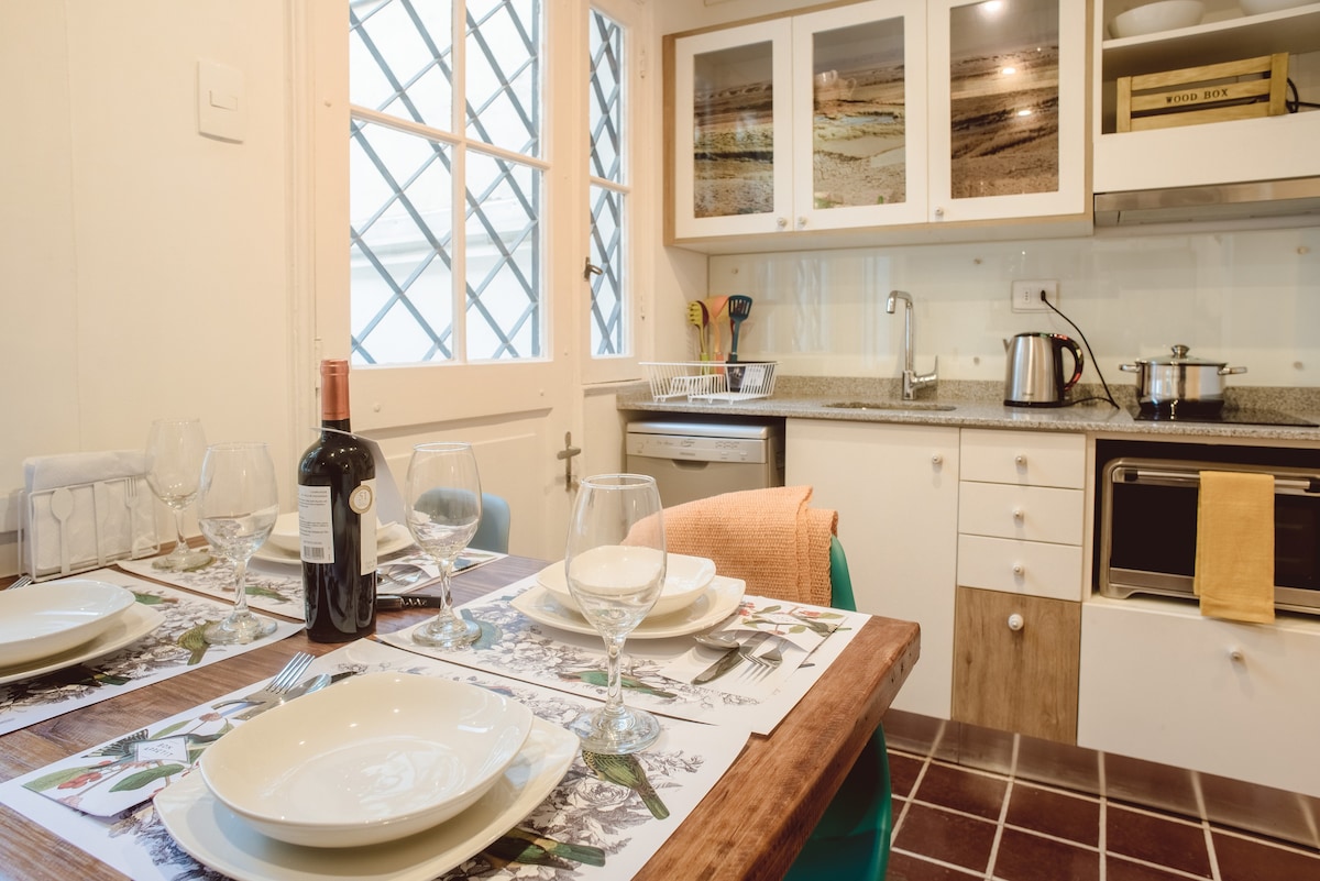 Cozy kitchen with a charming dining setup, perfect for intimate meals. Enjoy modern amenities and a warm, inviting atmosphere.