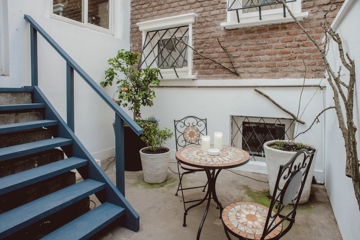 Charming patio retreat with mosaic table, perfect for morning coffee or evening relaxation.