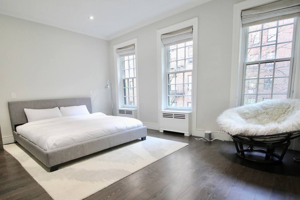 Private, Beautiful Upper Eastside Townhome — Master bedroom. Kingsized bed and pillow chair. Pillowtop innerspring mattress, 55' SUHD Samsung smart TV and ensuite master bath with walk-in closet and rainfall shower experience. 