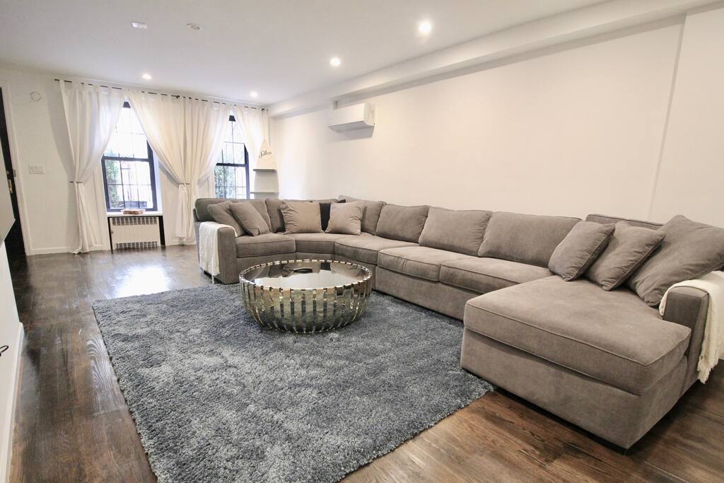 Private, Beautiful Upper Eastside Townhome — Cinema / Library / Lounge Area. Garden level entertainment area. 65' SUHD Samsung Smart TV. 