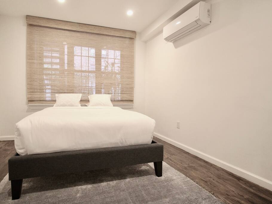 Private, Beautiful Upper Eastside Townhome — Garden floor guest bedroom. Full-sized bed. Pillowtop innerspring mattress.