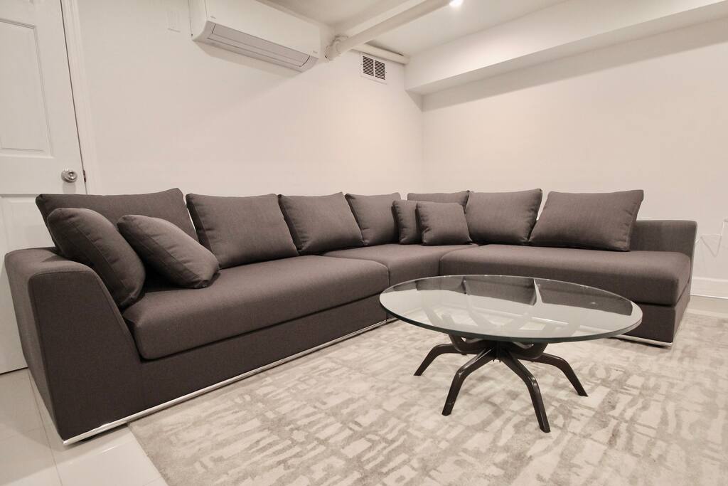 Private, Beautiful Upper Eastside Townhome — Lower level entertainment / lounge area. Jonathan Adler coffee table.