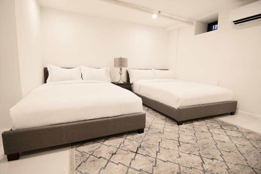 Private, Beautiful Upper Eastside Townhome — Lower level guest bedroom. 2 Full-sized beds and one sleeper-sofa. Pillowtop innerspring mattress, ensuite bath and walk-in closet.