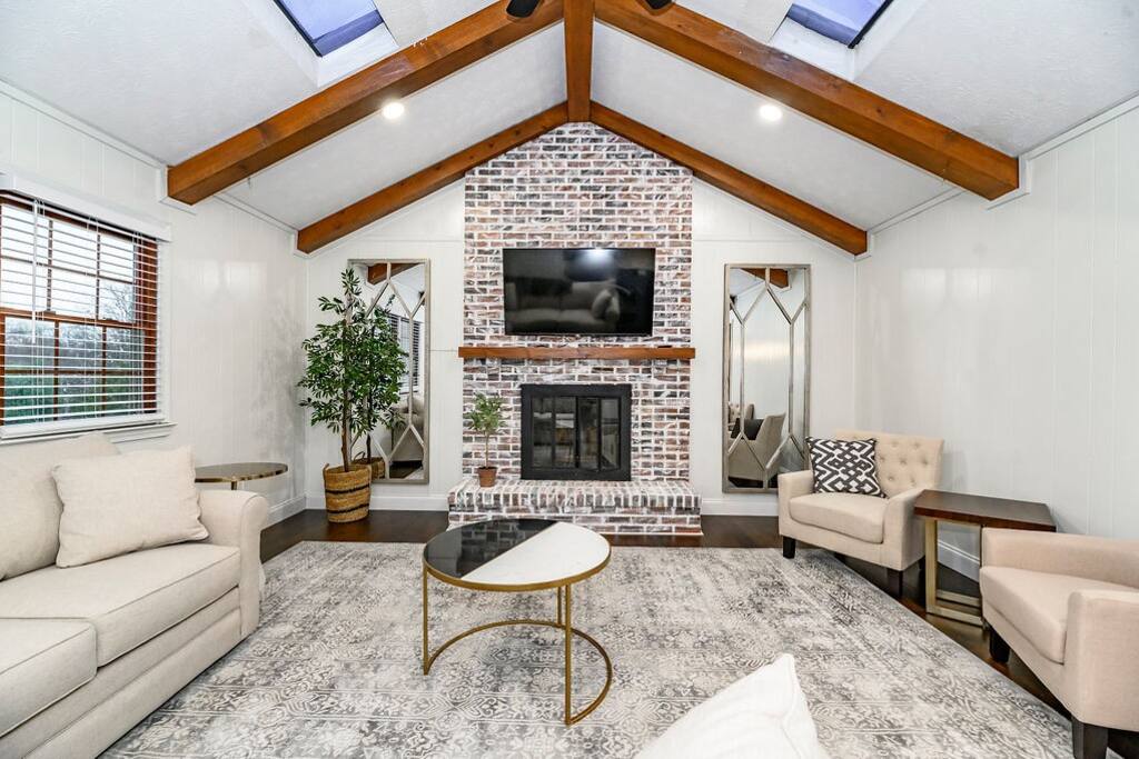 Kick your shoes off under the beams and let the fireplace do the talking — this is where the group ends up every single night, board game or not.