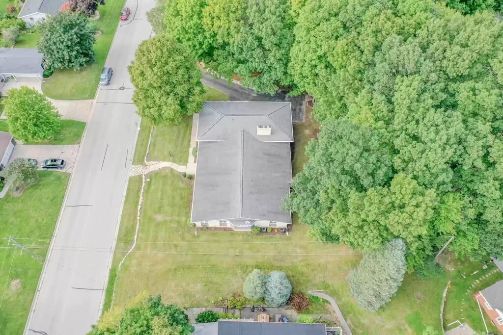 Arial view of the home, situated in a residential neighborhood.