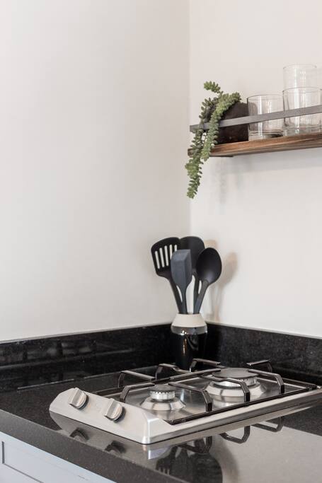 Kitchen with Stove Top and Cookware Essentials
