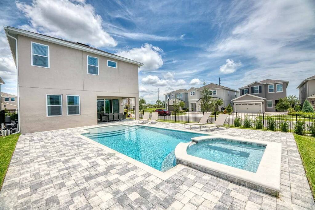 Dive into relaxation with this stunning pool and hot tub, perfect for soaking up the sun and enjoying outdoor leisure.