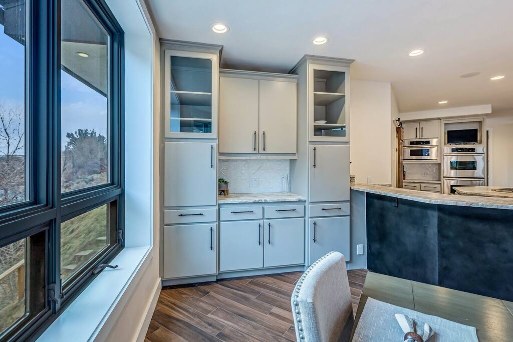 Sunlit breakfast area w/ easy access to the kitchen and outdoor views.