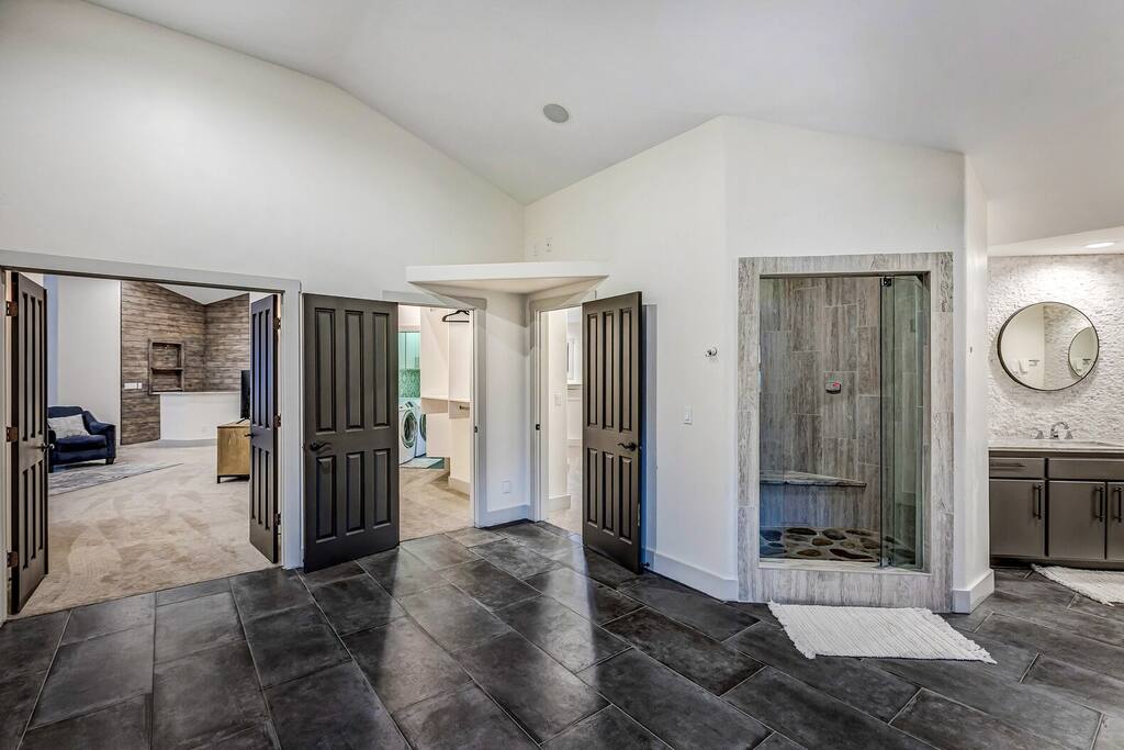 Open entryway and hallway w/ sleek flooring and easy flow between rooms.