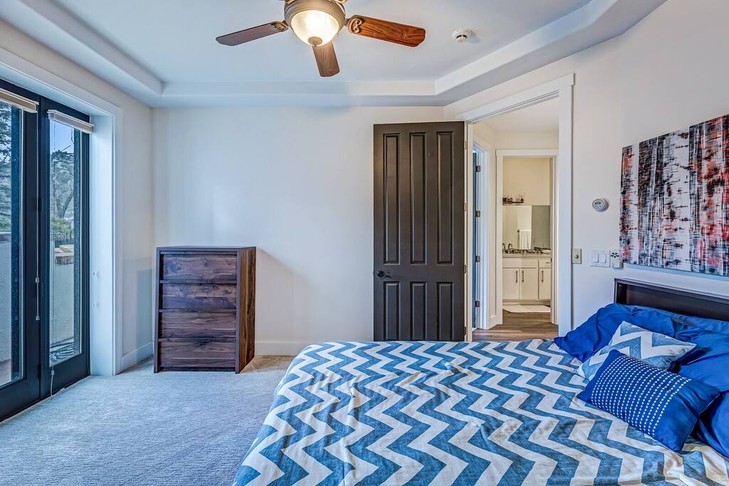 Bright bedroom w/ patterned flooring adding a playful, modern touch.