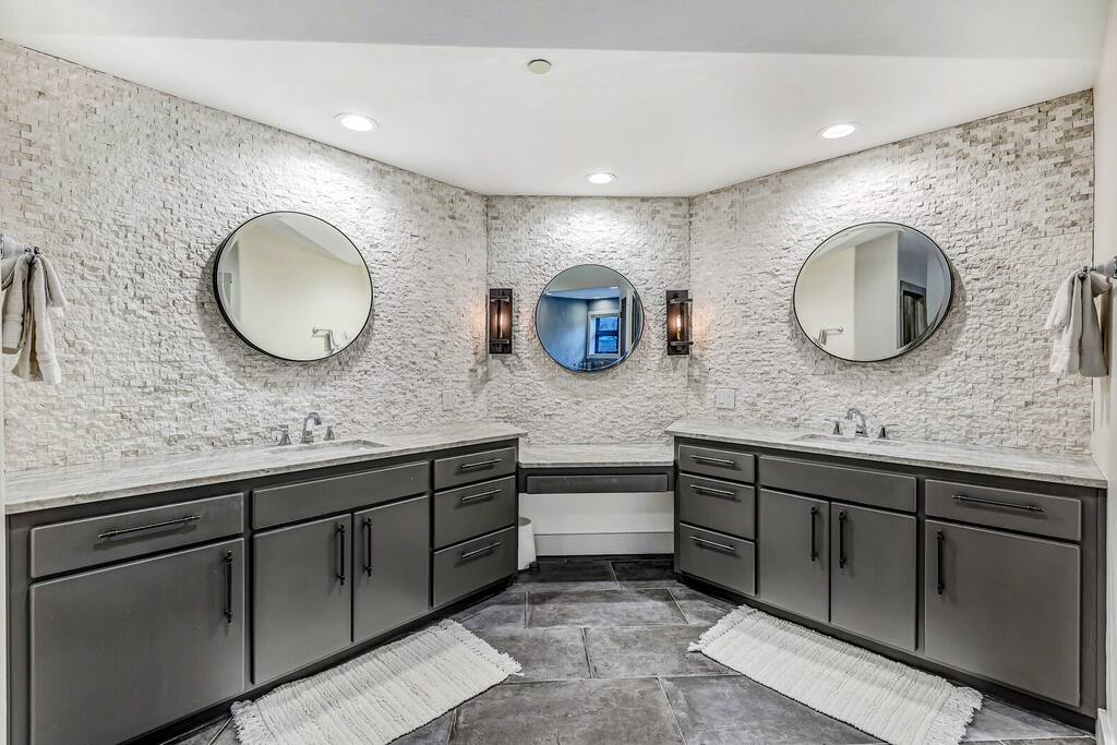 Modern bathroom w/ dual sinks and a clean, polished finish.