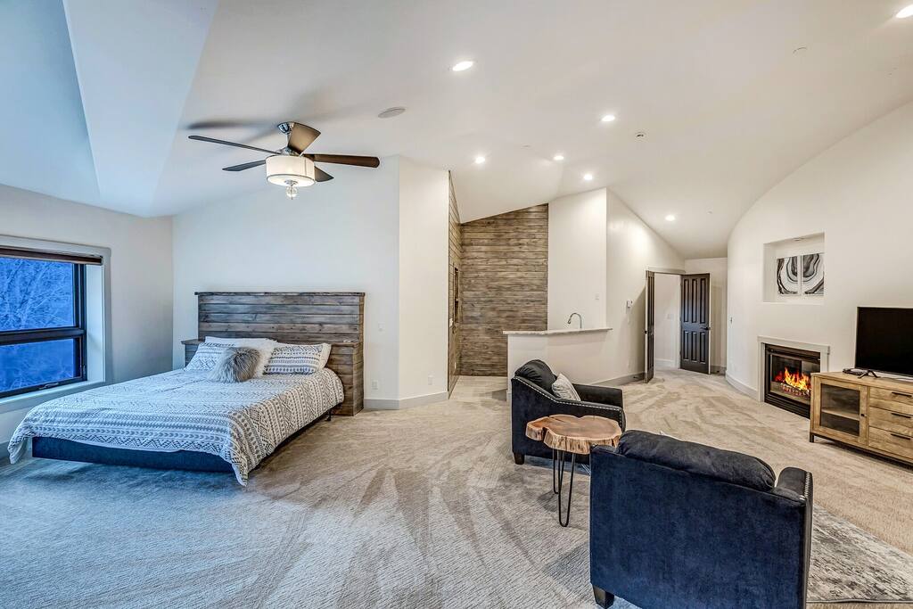 Bright open living area w/ comfy seating, ceiling fan, and plenty of natural light.