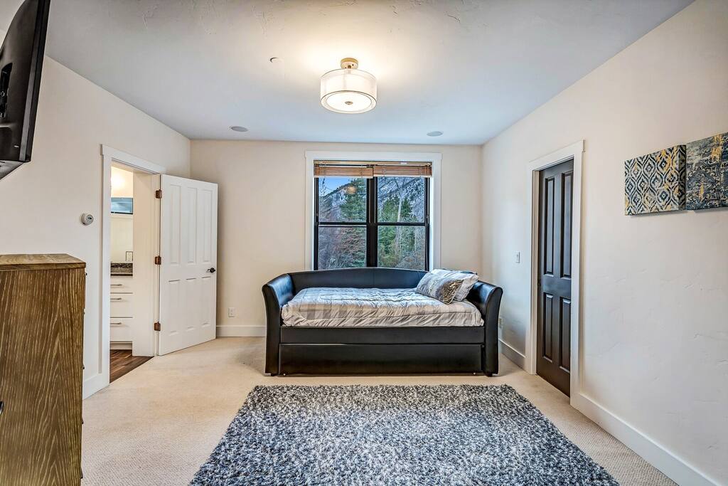 Calm bedroom retreat featuring a bed, soft lighting, and a peaceful, uncluttered layout.