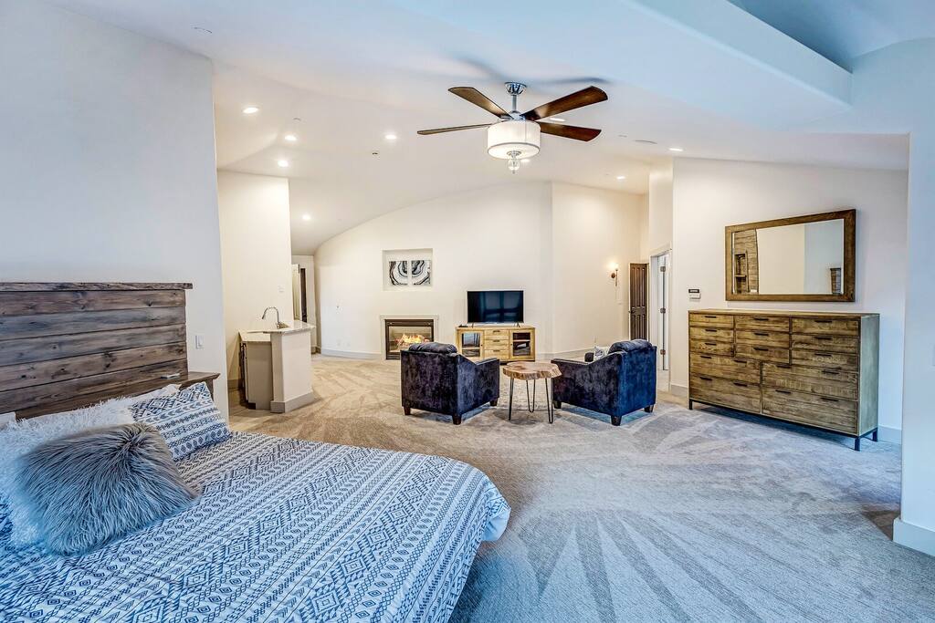 Airy great room blending lounge and dining spaces w/ soft light and an inviting, open feel.
