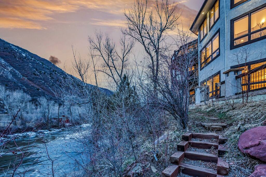 Wintery outdoor view capturing the home nestled among trees and snow.