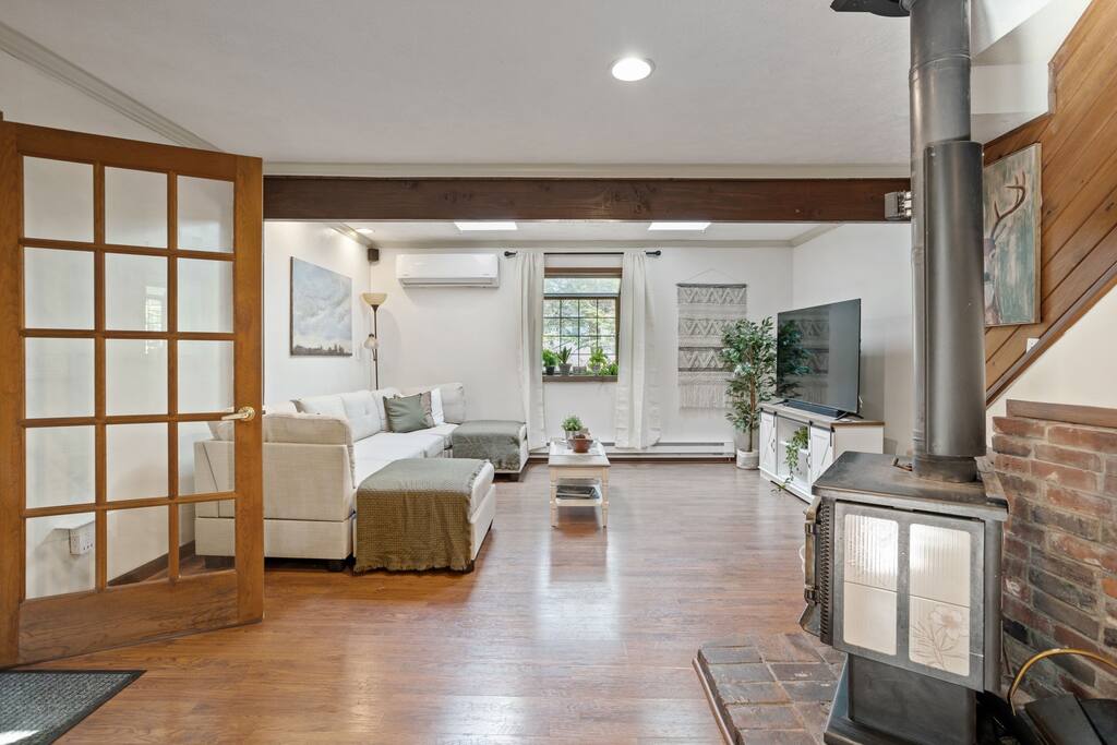 Living Room with Doors
Open and inviting with wood accents and a TV, this living room offers a great blend of cozy and contemporary comfort.