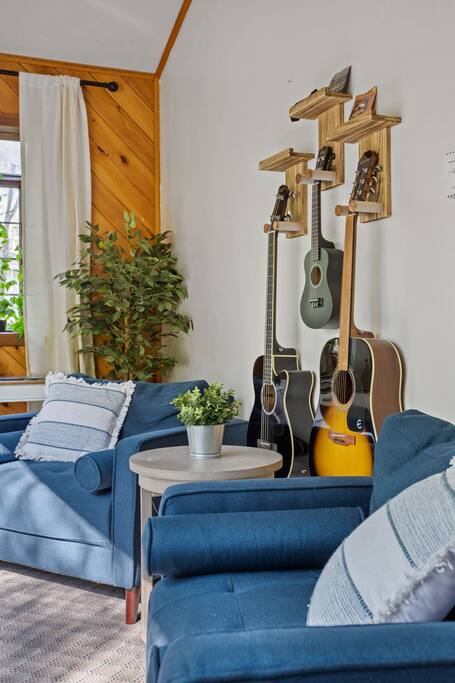 A cozy music corner with rich textures, vibrant greenery, and a curated guitar collection that sets the creative tone for your stay.