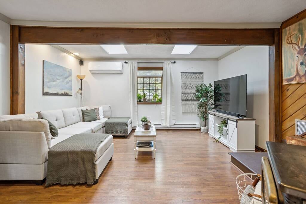 Wide Living Room Angle
This wide view shows off the entire layout of the main lounge, from sofa to TV to stairs, with enough space to gather or spread out.