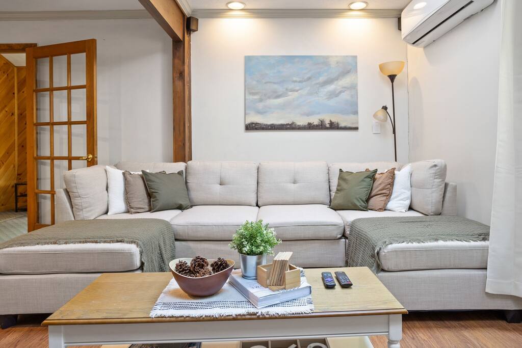 Front-Facing Sofa View
A centered, balanced view of the main seating area with layered cushions and soft lighting that make the space feel extra cozy.