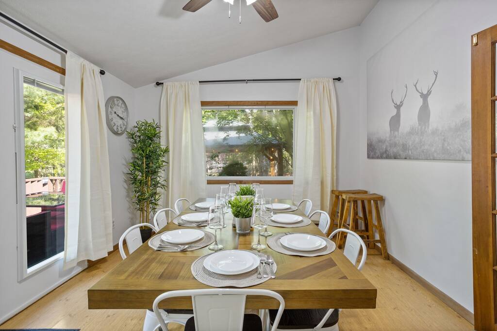Simple, stylish, and functional. This dining room view blends natural light, cozy wall decor, and enough seating for everyone to gather comfortably