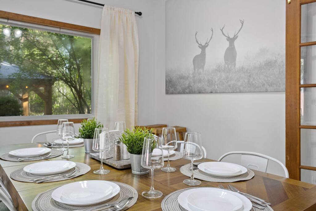 A close-up look at the place settings and gentle light pouring in through the windows, showing off the thoughtful, homey vibe.