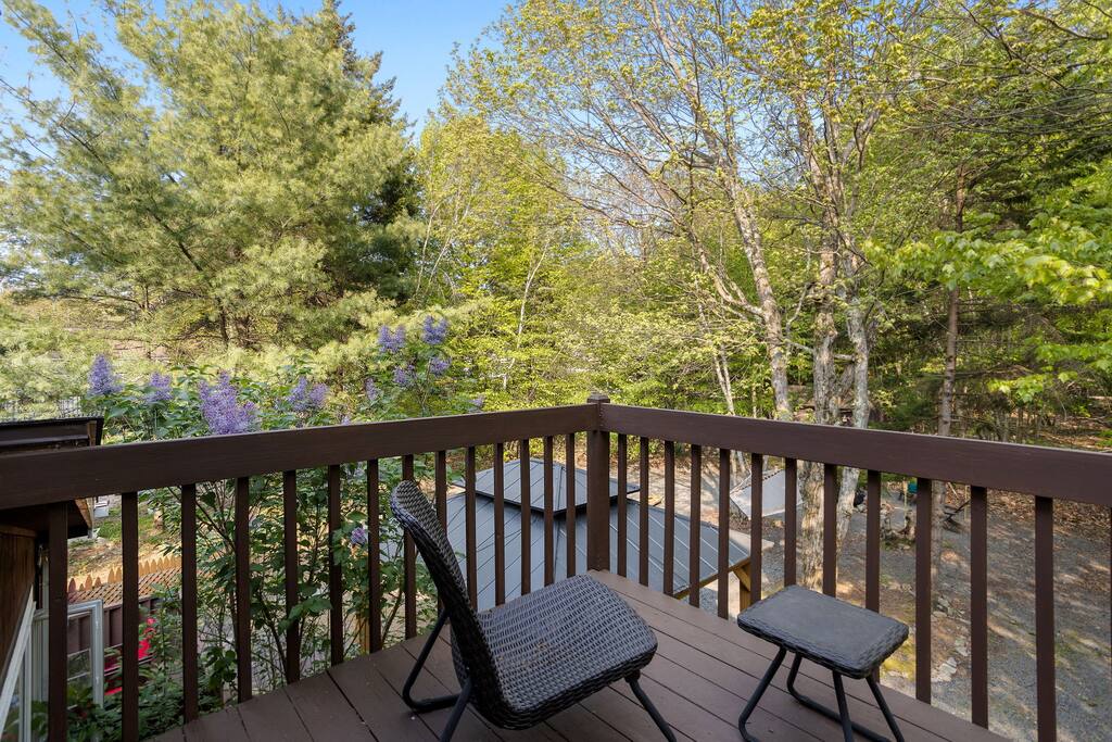 Step outside and enjoy your own slice of nature with this private balcony overlooking trees and blue sky, perfect for morning coffee or evening chats.