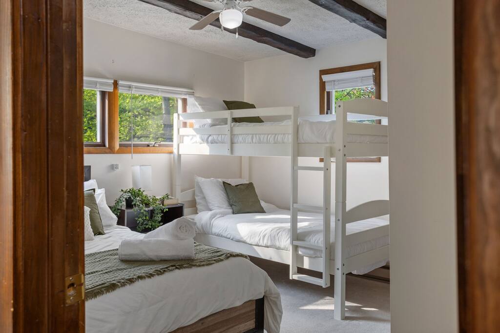Bunk Room Entry View
With rustic beams, 1 bunk, 1 double bed, and soft green tones, this playful room is ideal for younger guests or a fun sleepover setup.