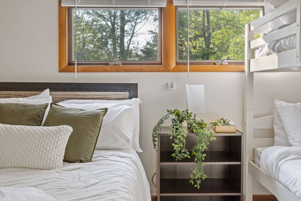 A sweet touch of green and natural light by the window adds a peaceful energy to this bright and thoughtful space.