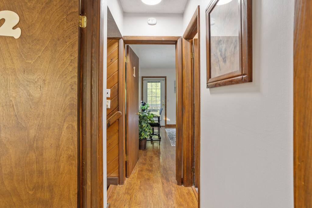 Hallway to Common Areas
This warm, wood-accented hallway guides you through the heart of the home, connecting bedrooms to shared spaces with ease.